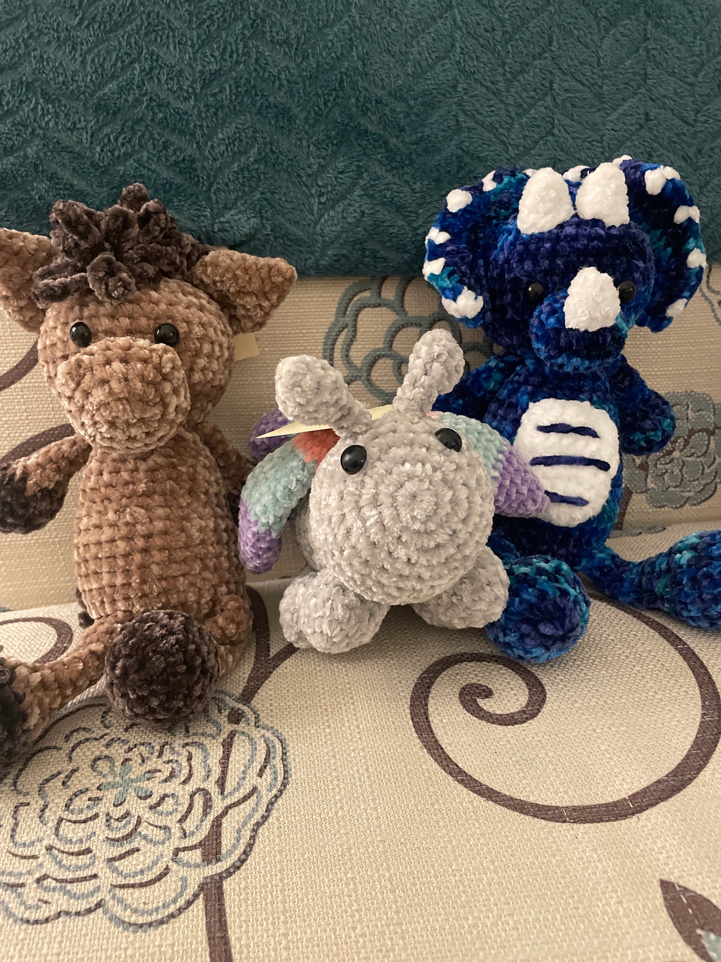 Velvet stuffed animals, crocheted butterfly, dinosaur and horse